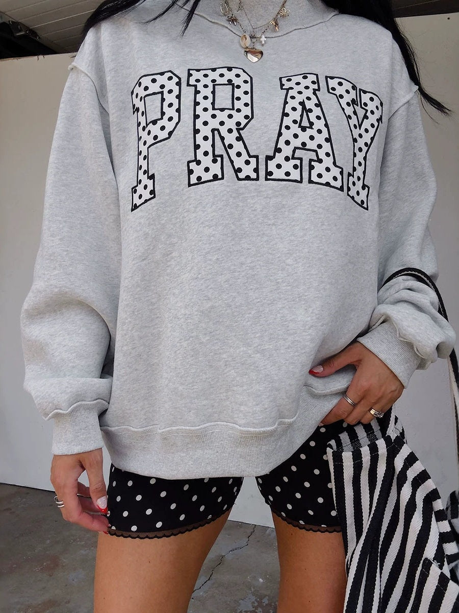 Women's gray raglan sweatshirt with 'PRAY' polka-dot letter graphic