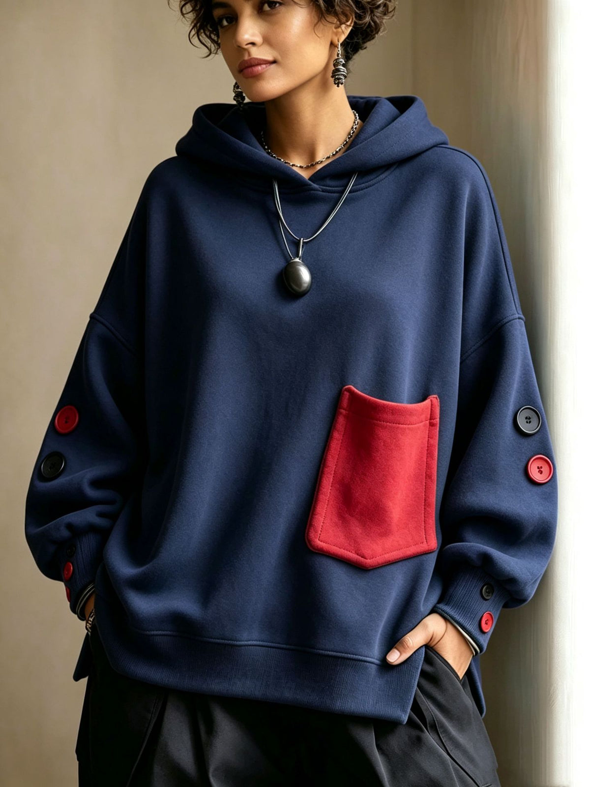 Navy pullover hoodie with front kangaroo pocket, hood drawstrings, buttoned sleeve cuffs