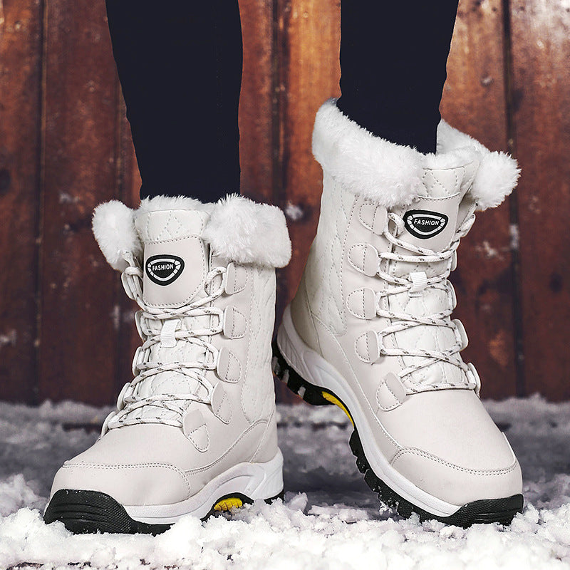 White high-top snow boots with faux-fur collar, buckled laces, and tread sole