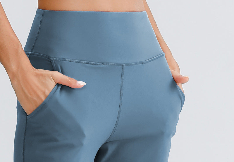 Women's blue yoga pants close-up of waistband and side pocket stitching