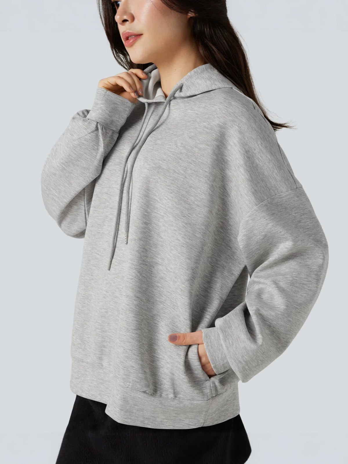 Light gray women's pullover hoodie with hood, drawstrings, and kangaroo pocket