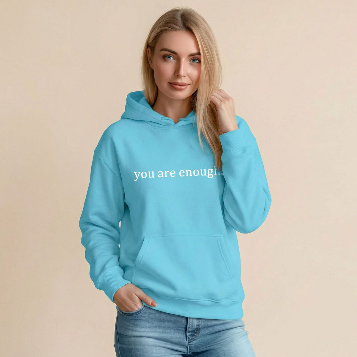 Light blue women’s hoodie sweatshirt with hood, front pocket, and 'you are enough' print.