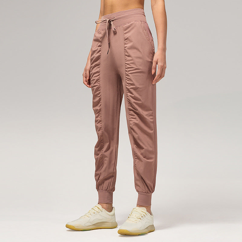 Women’s loose rose taupe jogger pants with drawstring waist and cuffed ankles, side pockets.