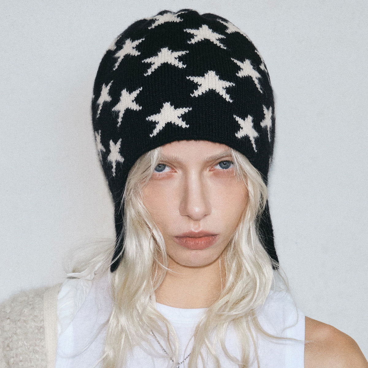 Black knit beanie with white stars, women’s winter cold-weather hat