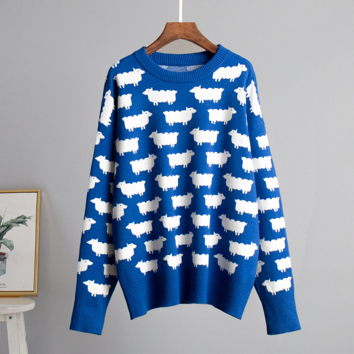 Women’s crewneck knit sweater, blue with white sheep pattern, long sleeves