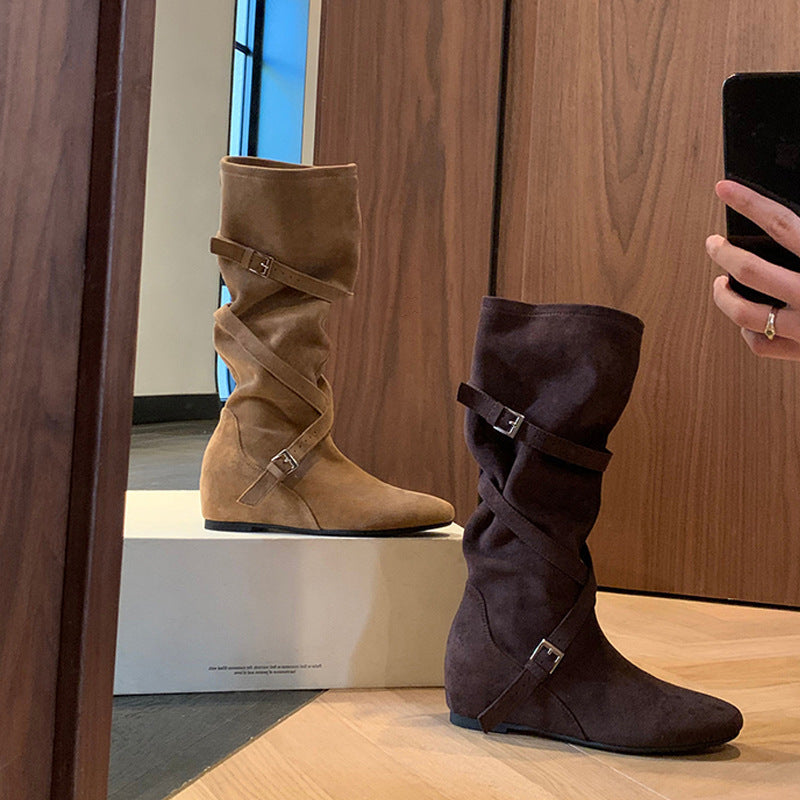 Pair of slouchy boots: tan and dark, with buckle straps and low wedge heel.