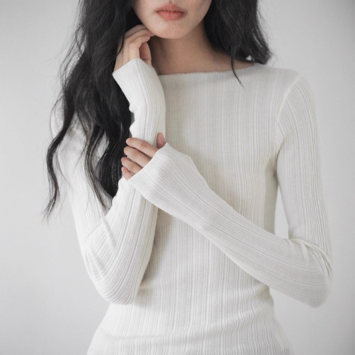 Women's white ribbed knit long-sleeve fitted top, crew neck close-up
