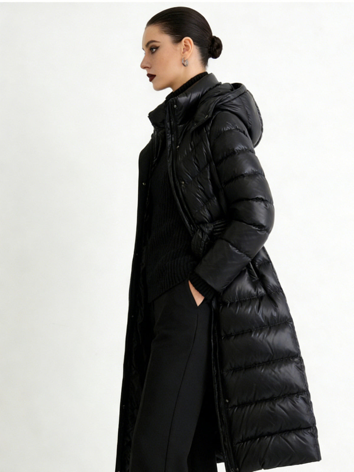 Women's black hooded long quilted puffer jacket, front zipper and waist belt