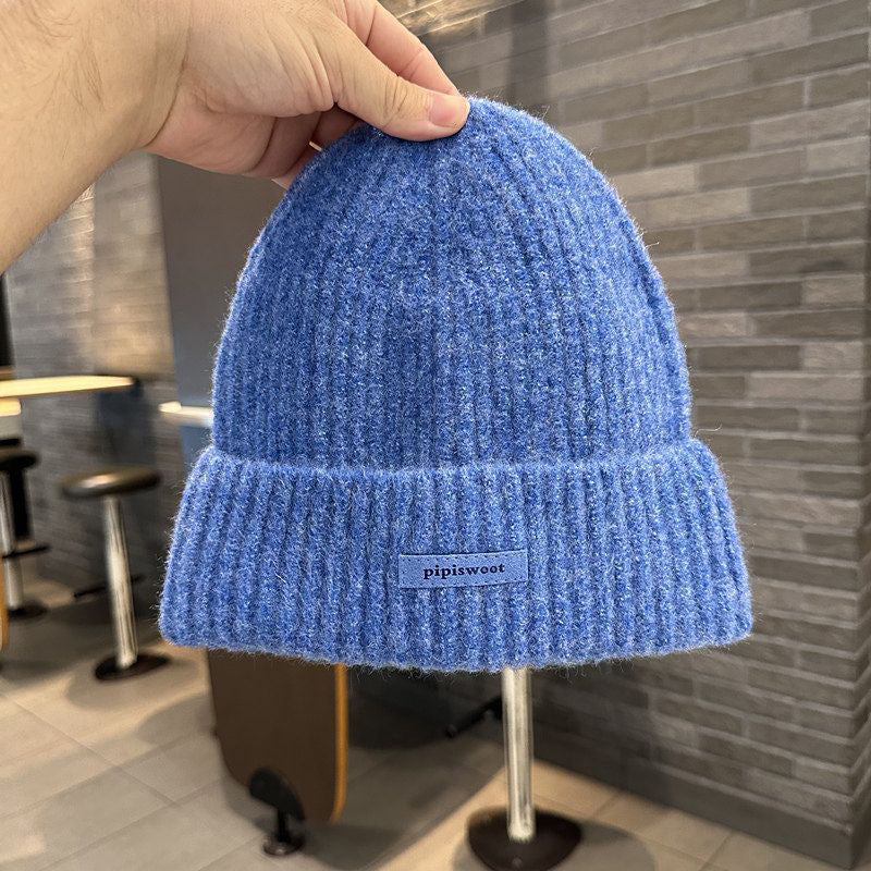 Blue ribbed knit beanie hat with folded brim and pipiswoot logo patch