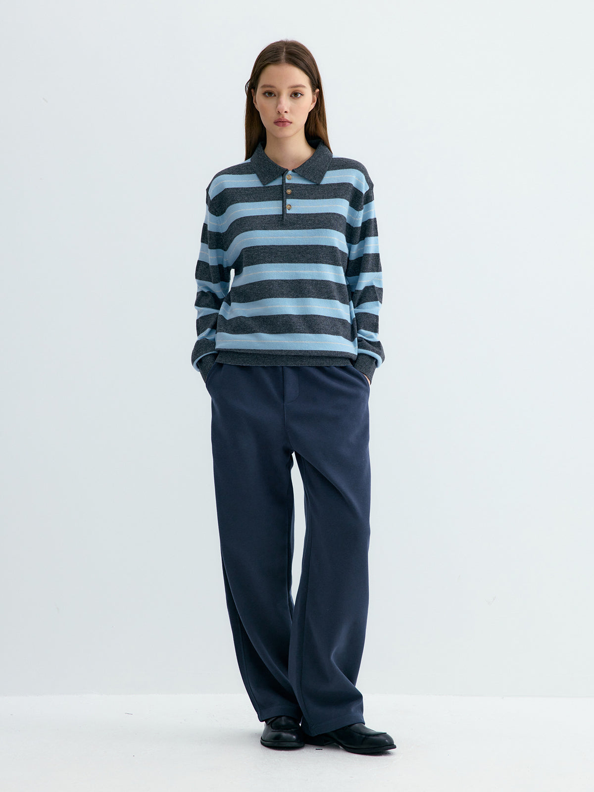 Dark blue loose knit sweatpants with straight wide legs and elastic waistband