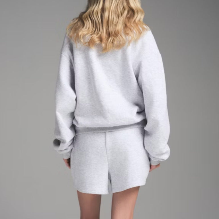 Women’s light gray sweatshirt and shorts set, back view with crew neck and relaxed shorts.