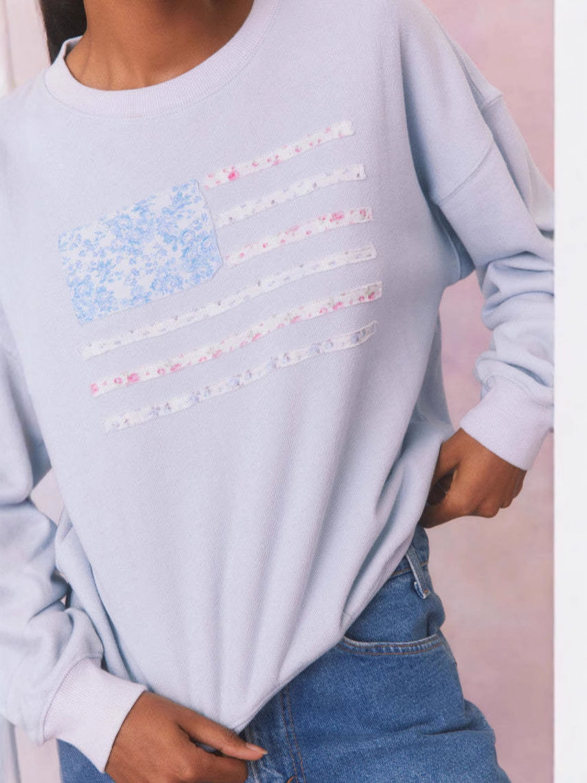 Blue crewneck velvet sweatshirt with flag stripe graphic print and long sleeves