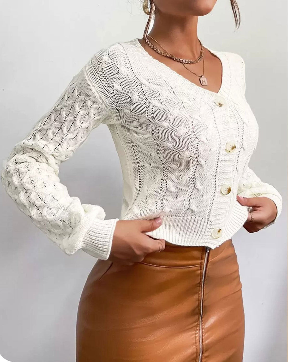 Milky white women’s v-neck cable-knit cardigan with button front and long sleeves