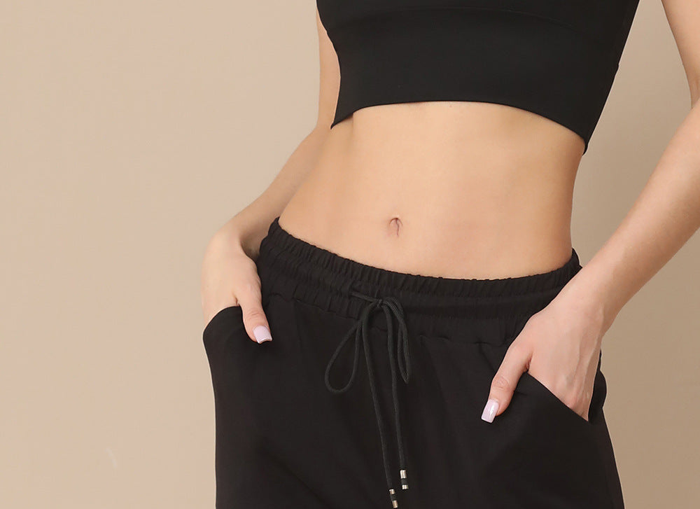 Black jogger pants with elastic waistband, drawstring, and visible pocket opening