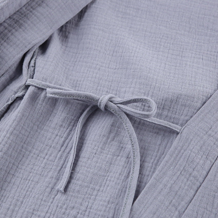 Grey gauze robe close-up of wrap belt tie and layered seam near the waist