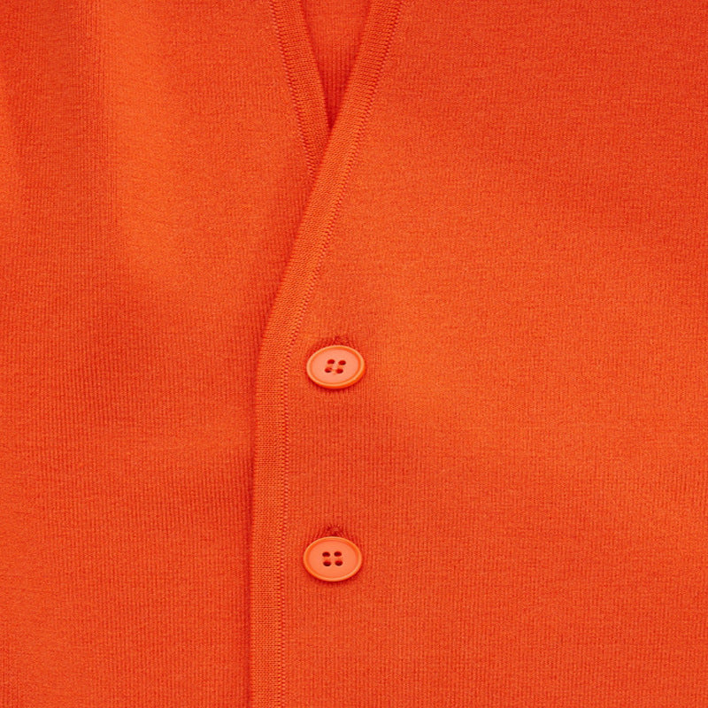 Orange cardigan button detail on fine-gauge knit