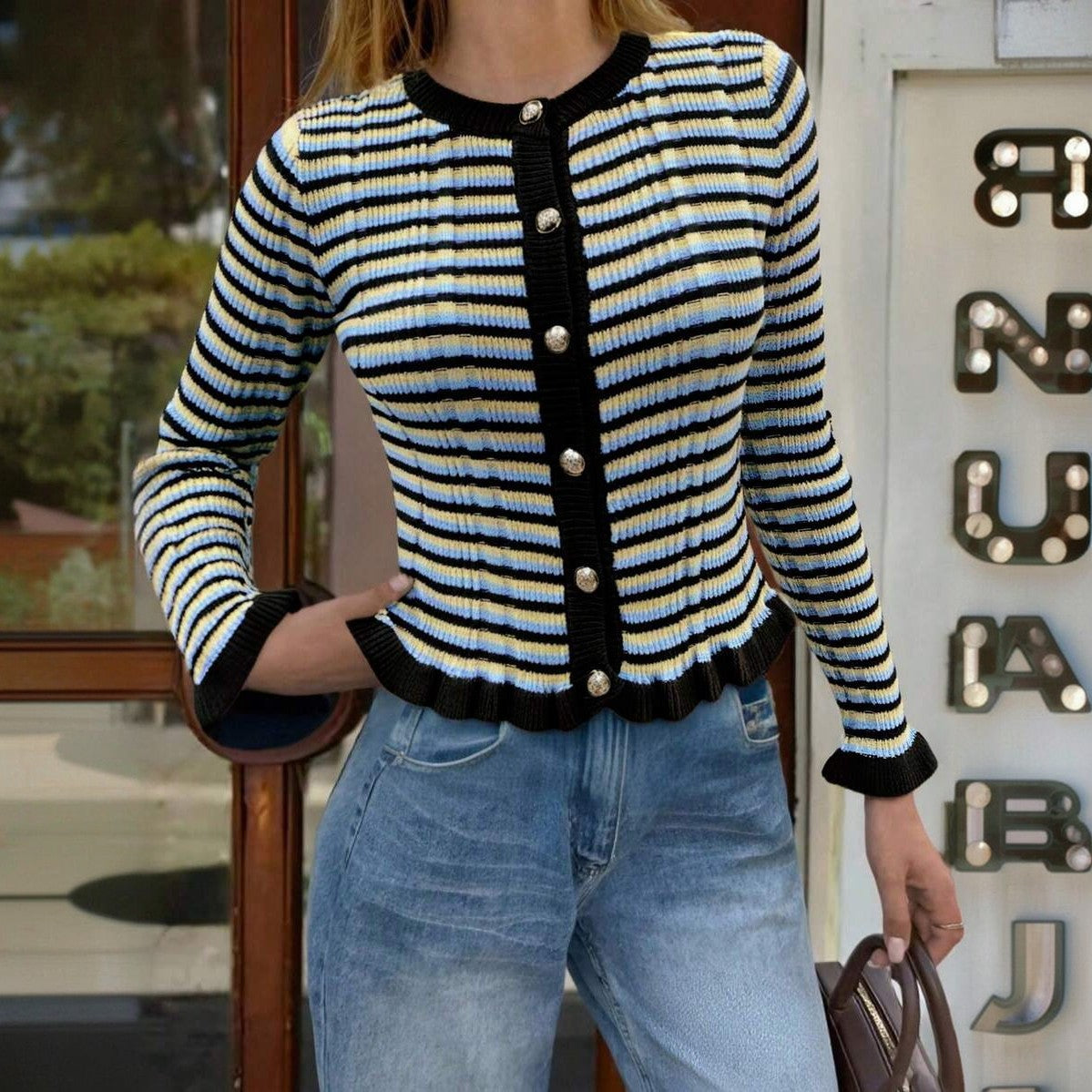Striped ribbed cardigan with black button-front, round neck, lettuce hem; blue/cream stripes.