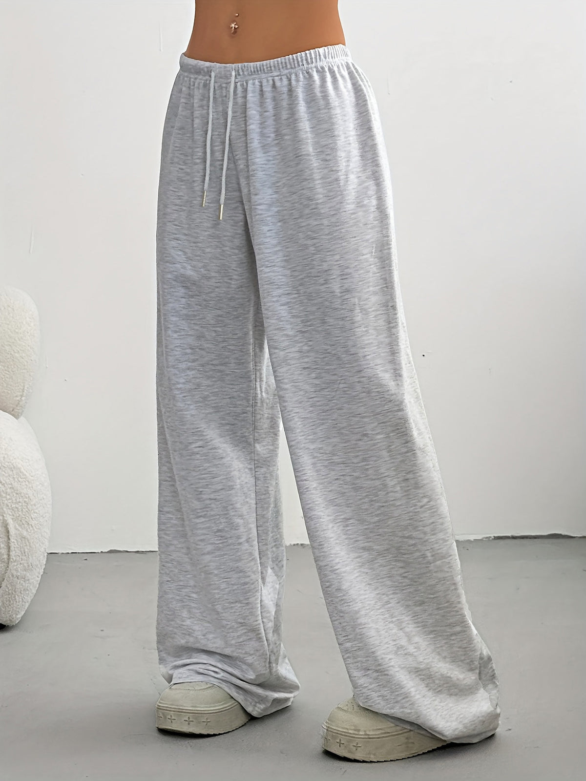 Women's high-waisted wide-leg sweatpants in light gray, side view with drawstring.