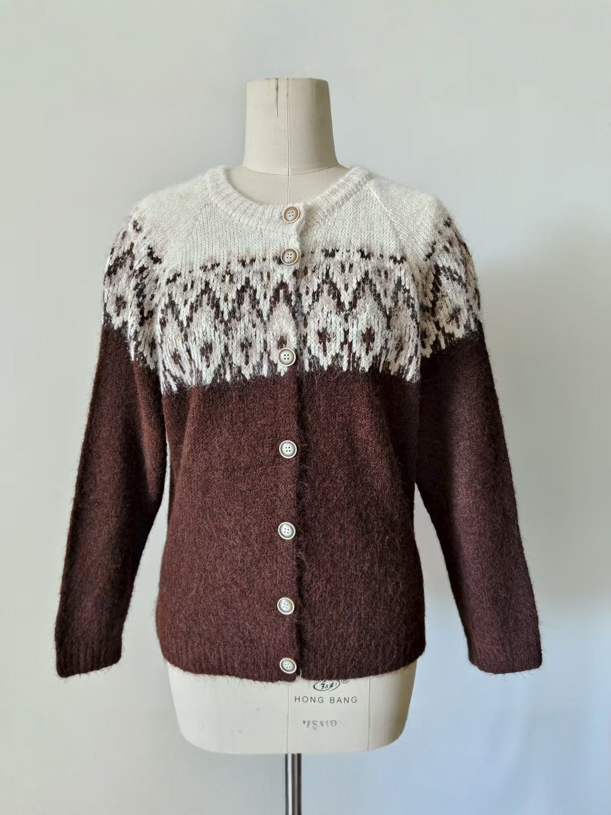 Brown Fair Isle knit cardigan sweater on mannequin with button front