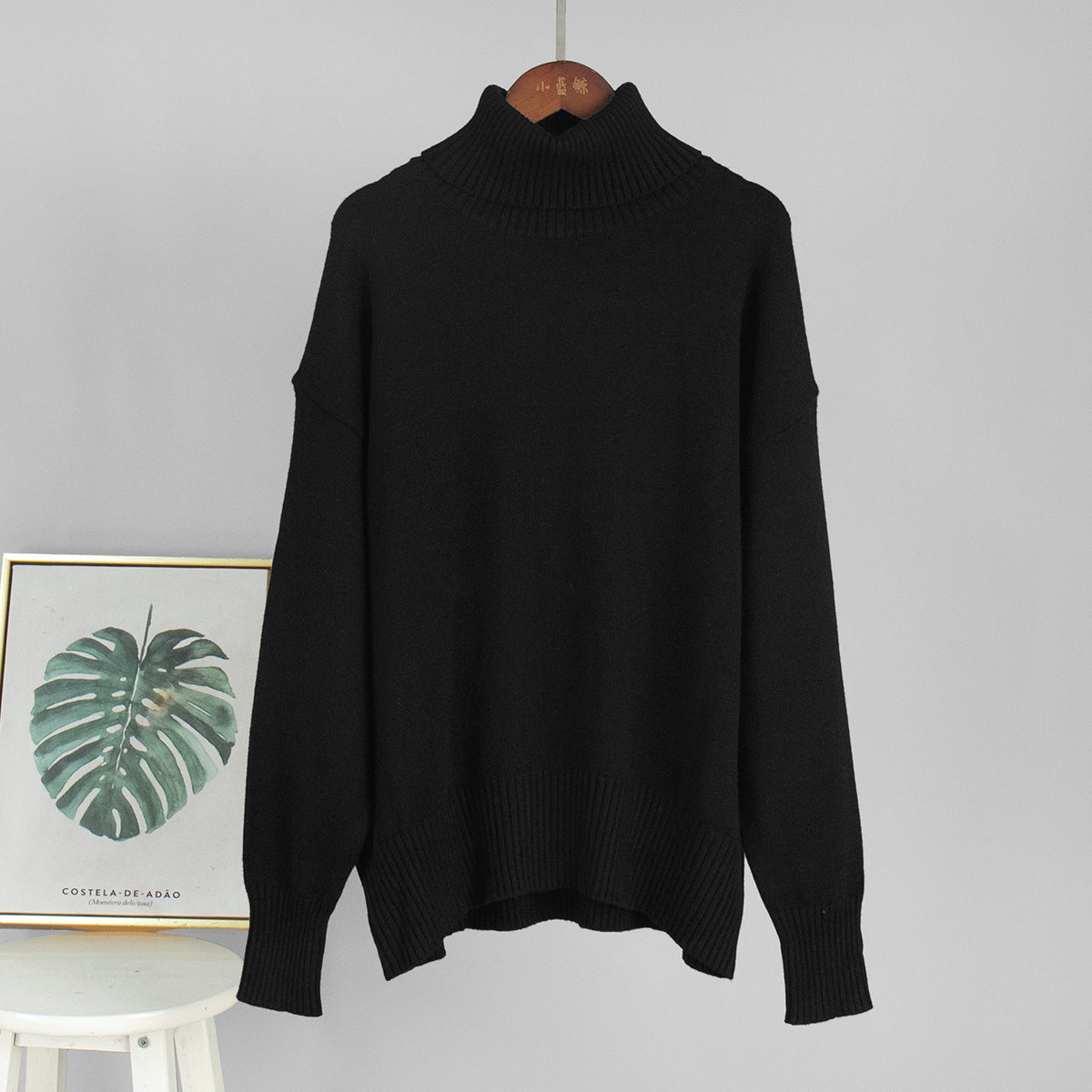 Black knit turtleneck pullover sweater with loose fit and ribbed cuffs