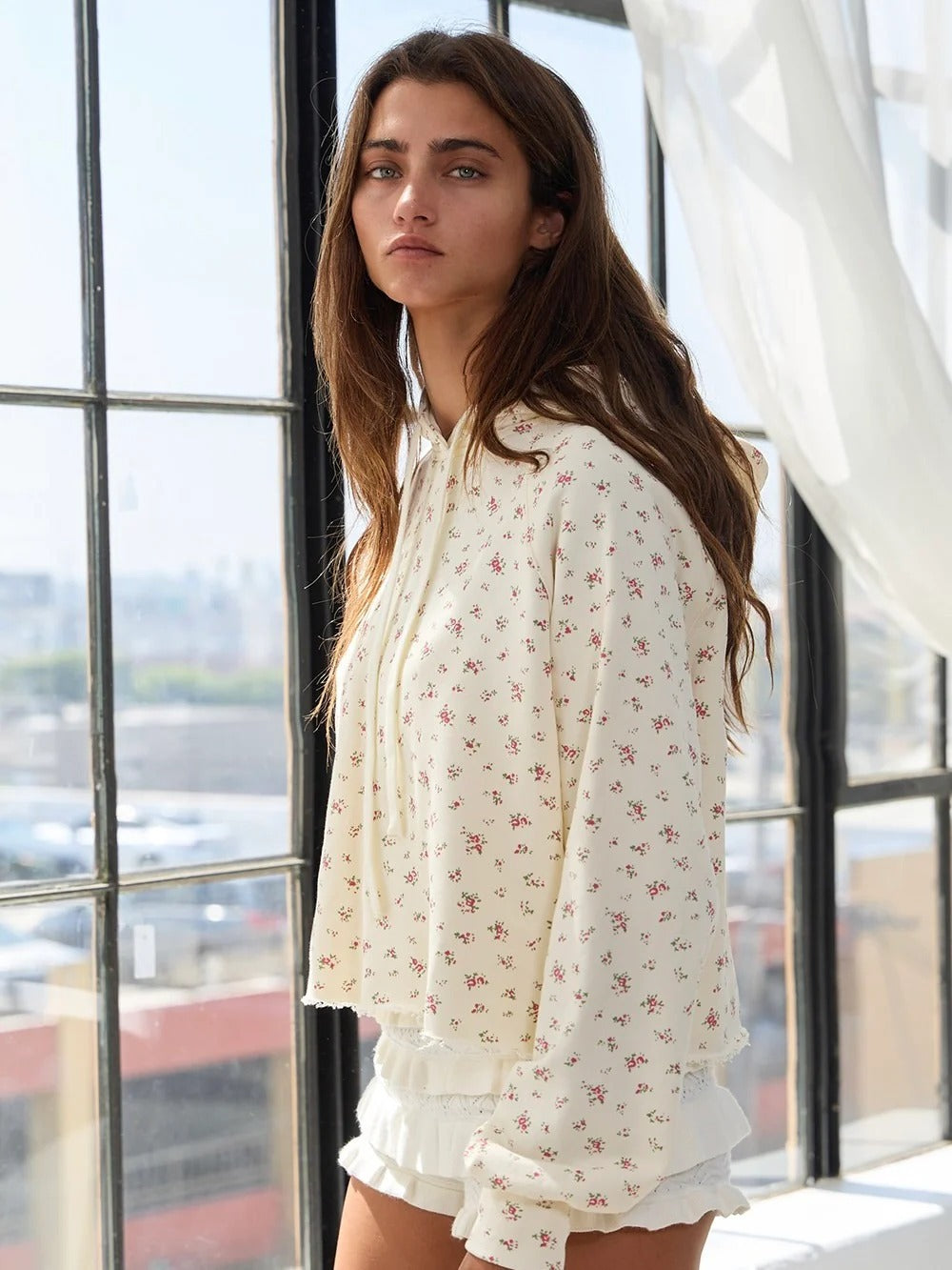 Apricot floral print pullover hoodie with hood, long sleeves, and ruffled cuffs and hem