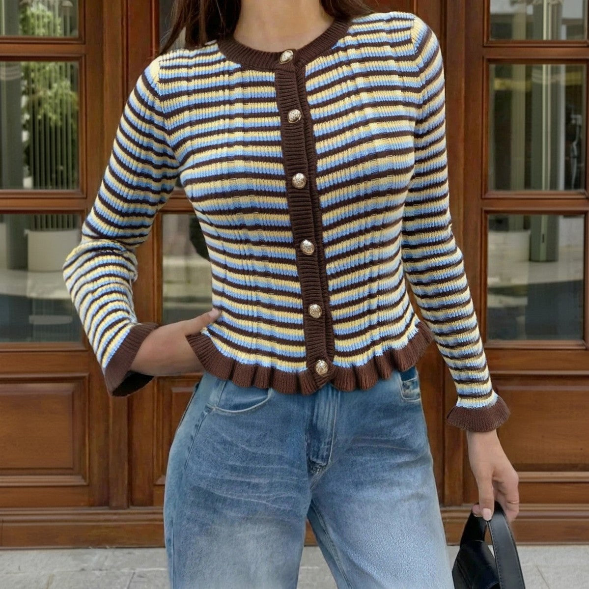 Striped ribbed cardigan with dark button-front and round neck; blue/cream stripes, lettuce hem.