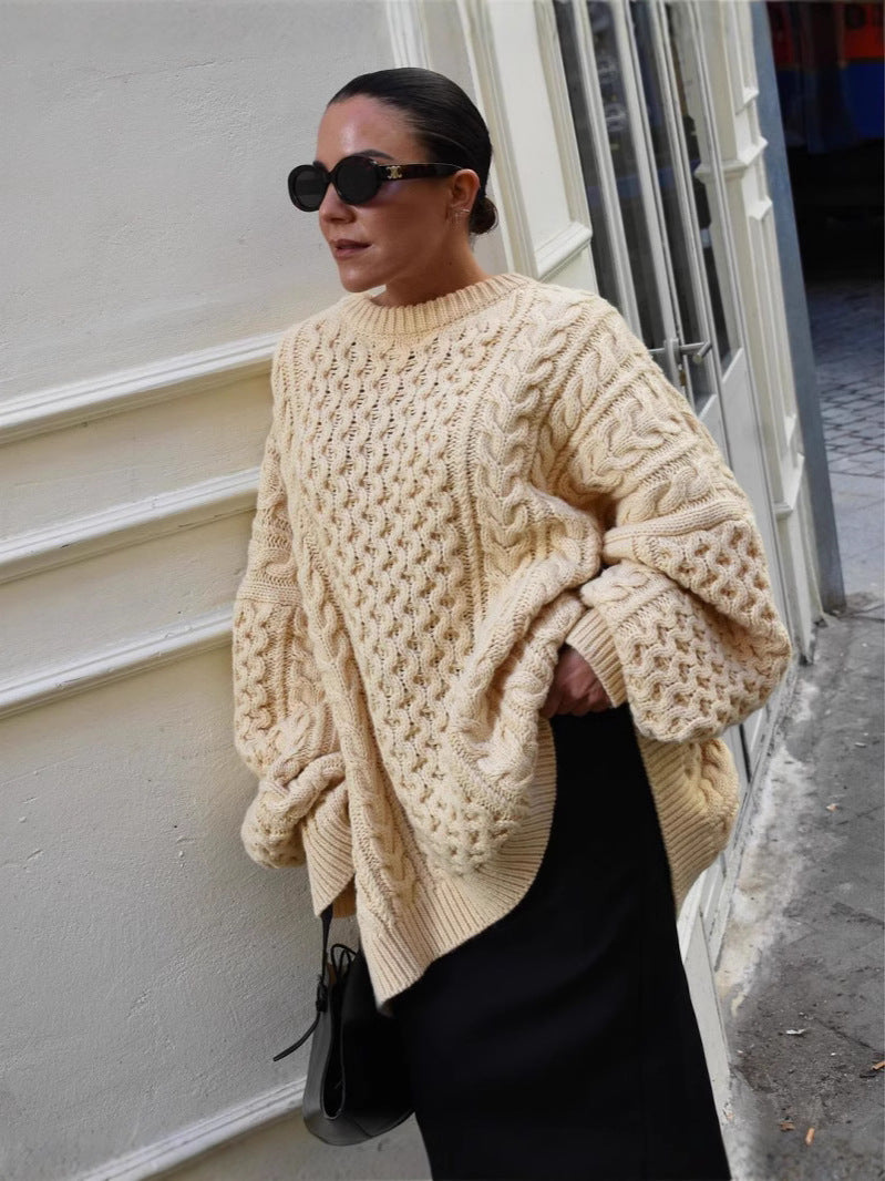 Beige cable-knit turtleneck sweater with oversized sleeves and textured cable design