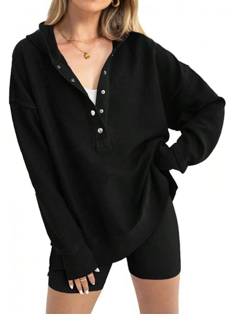 Black hooded henley sweatshirt detail: button placket and ribbed cuffs