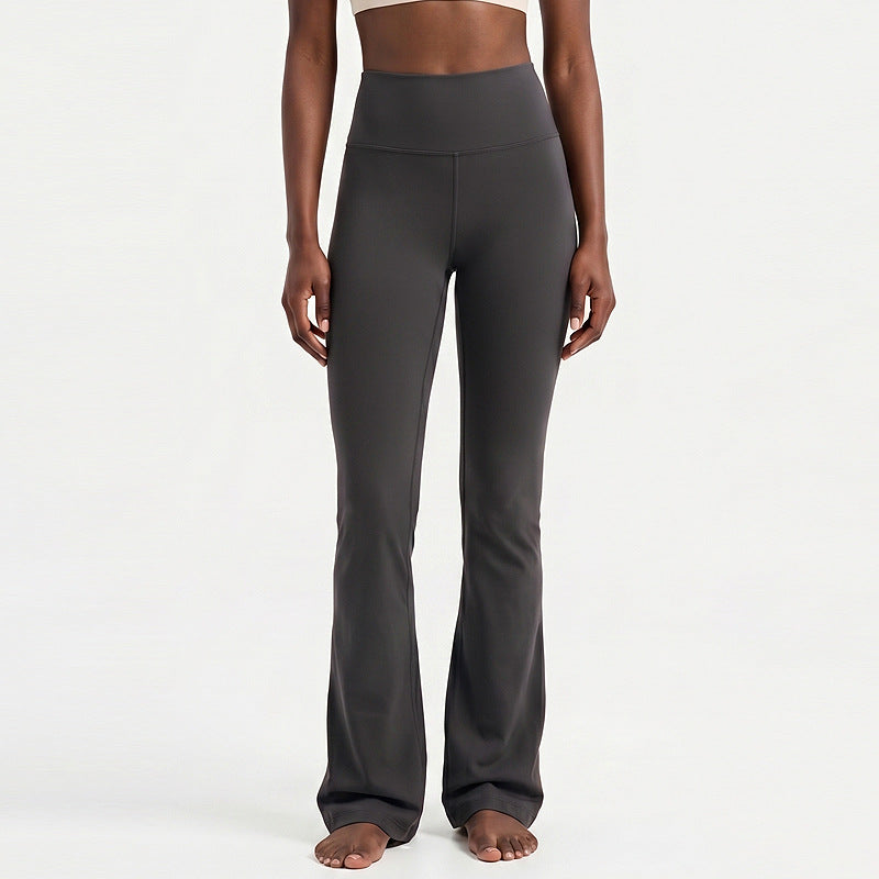High-waisted flare yoga pants in dark gray, smooth finish with long flared hem