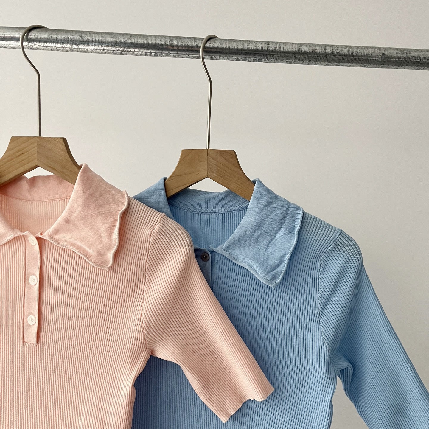 Women's knit polo collar close-ups in blush and blue, button placket, fine ribbed knit.