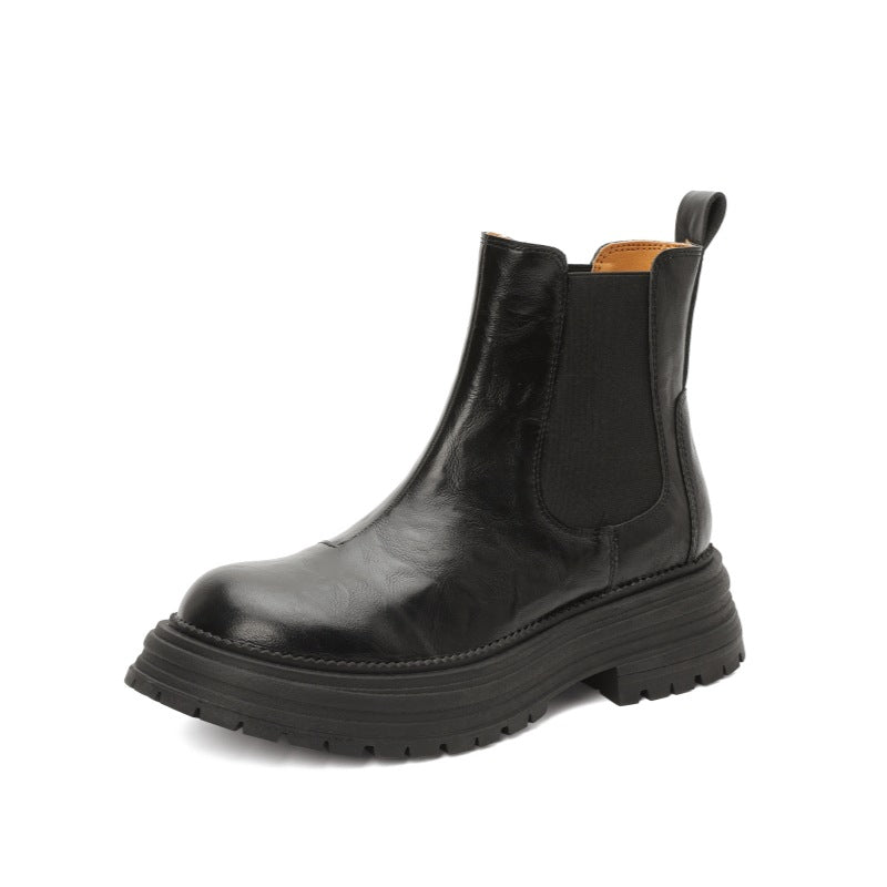 Black leather Chelsea boots with elastic side panels and thick platform lug sole