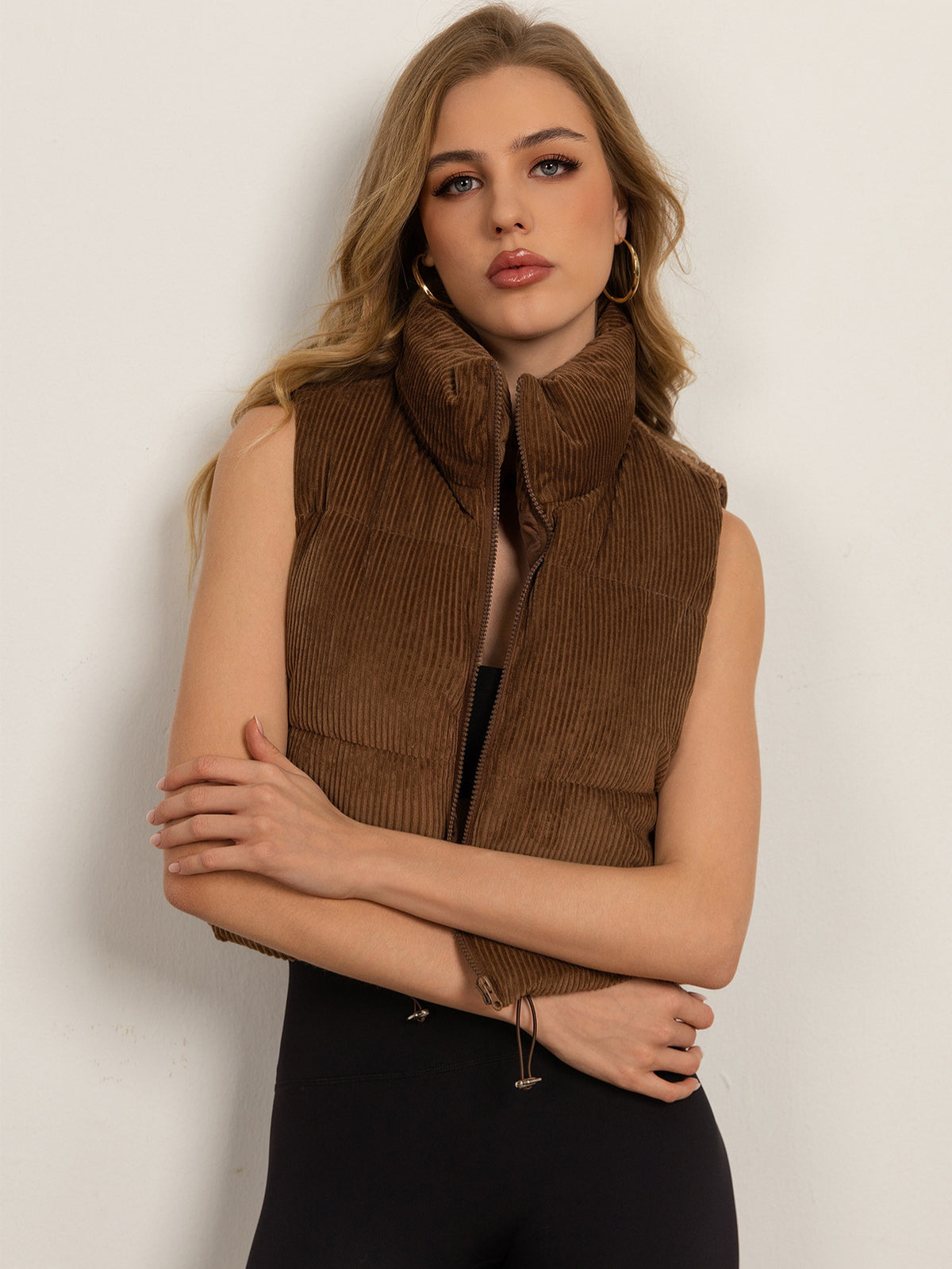Women’s sleeveless brown puffer vest with stand collar and front zipper