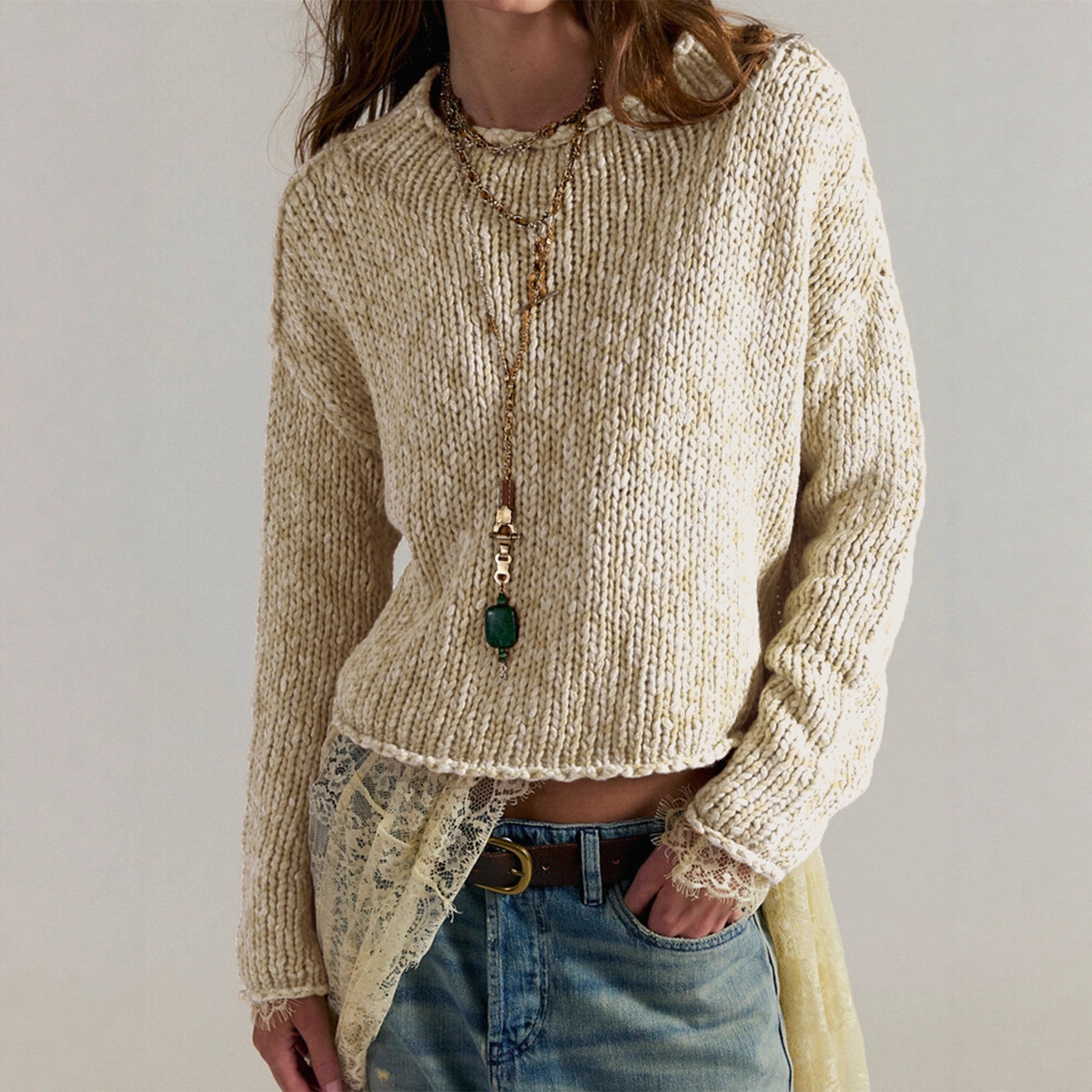 Women’s cream knit sweater top with round neck, long sleeves, textured ribbed hem