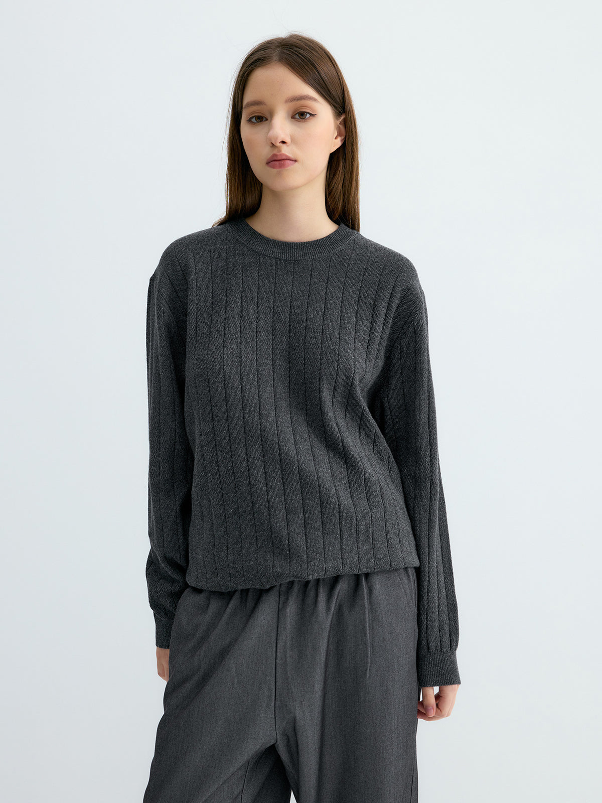 Dark gray ribbed knit sweater with vertical stripes, round neck and roomy fit.