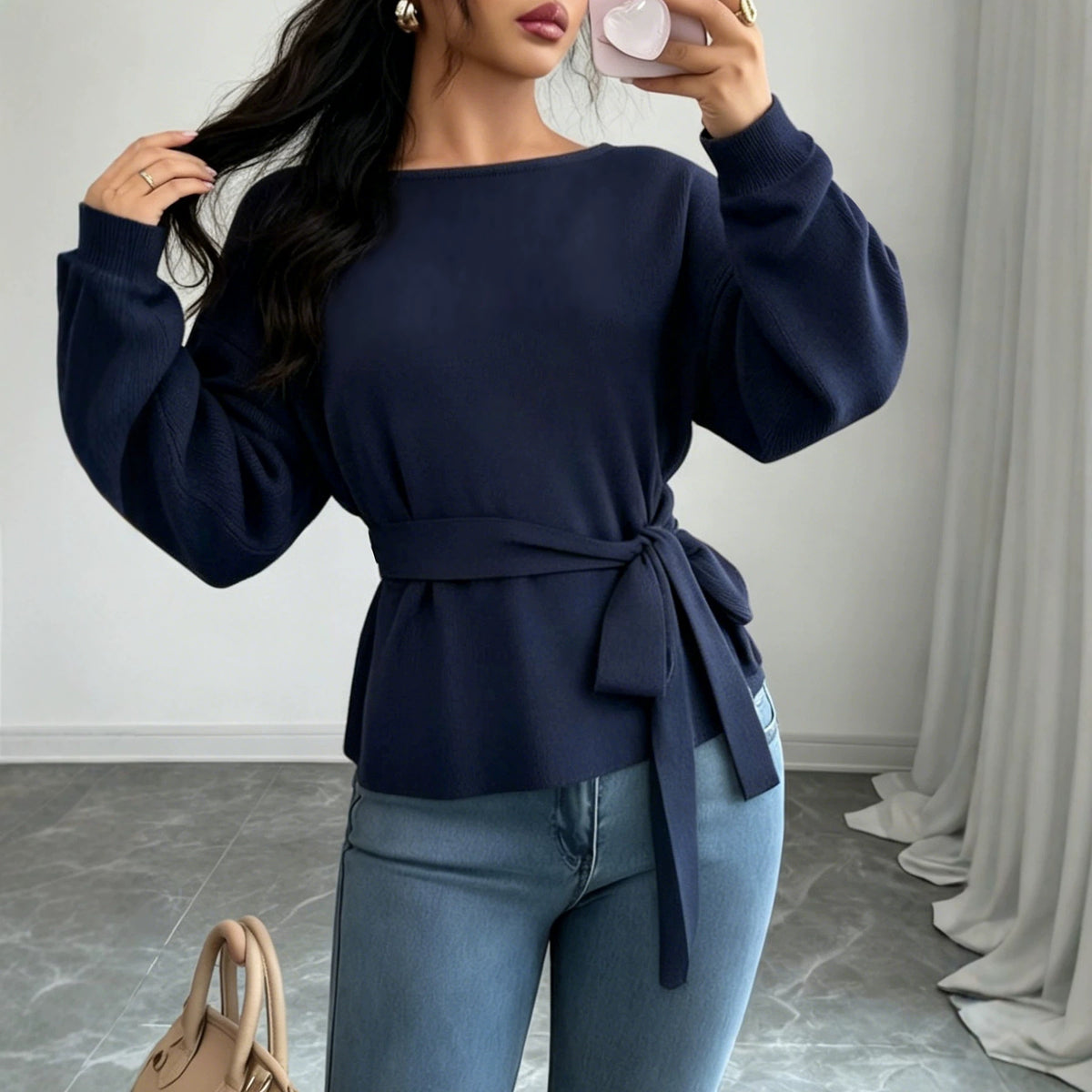 Women's dark blue knit sweater with voluminous sleeves and a long waist tie