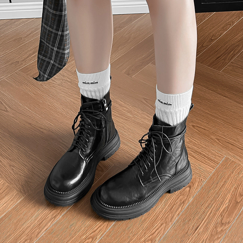 Black lace-up ankle combat boots with stacked sole and decorative seams