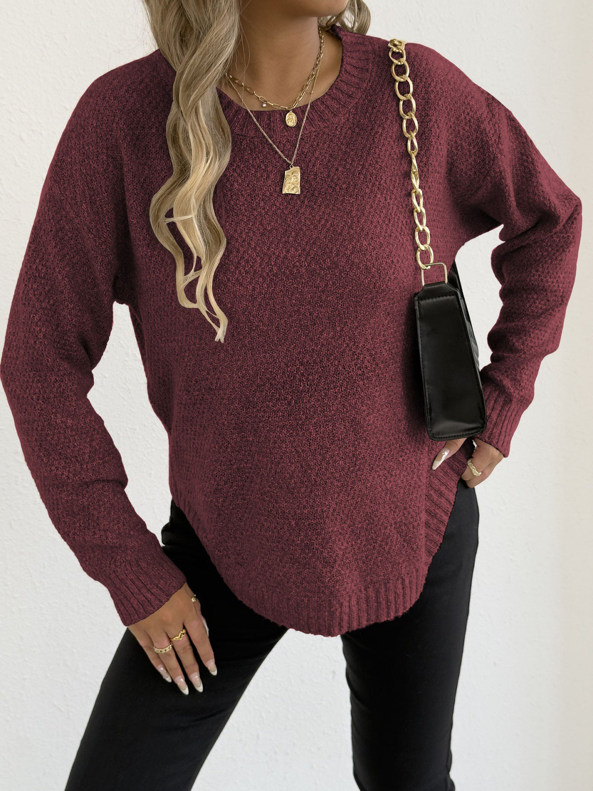 Wine red knit pullover sweater with round neckline and long sleeves