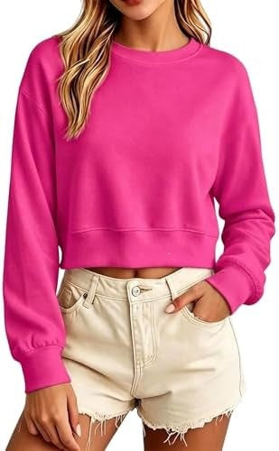Bright pink cropped sweatshirt with a crew neck, loose long sleeves, and ribbed cuffs