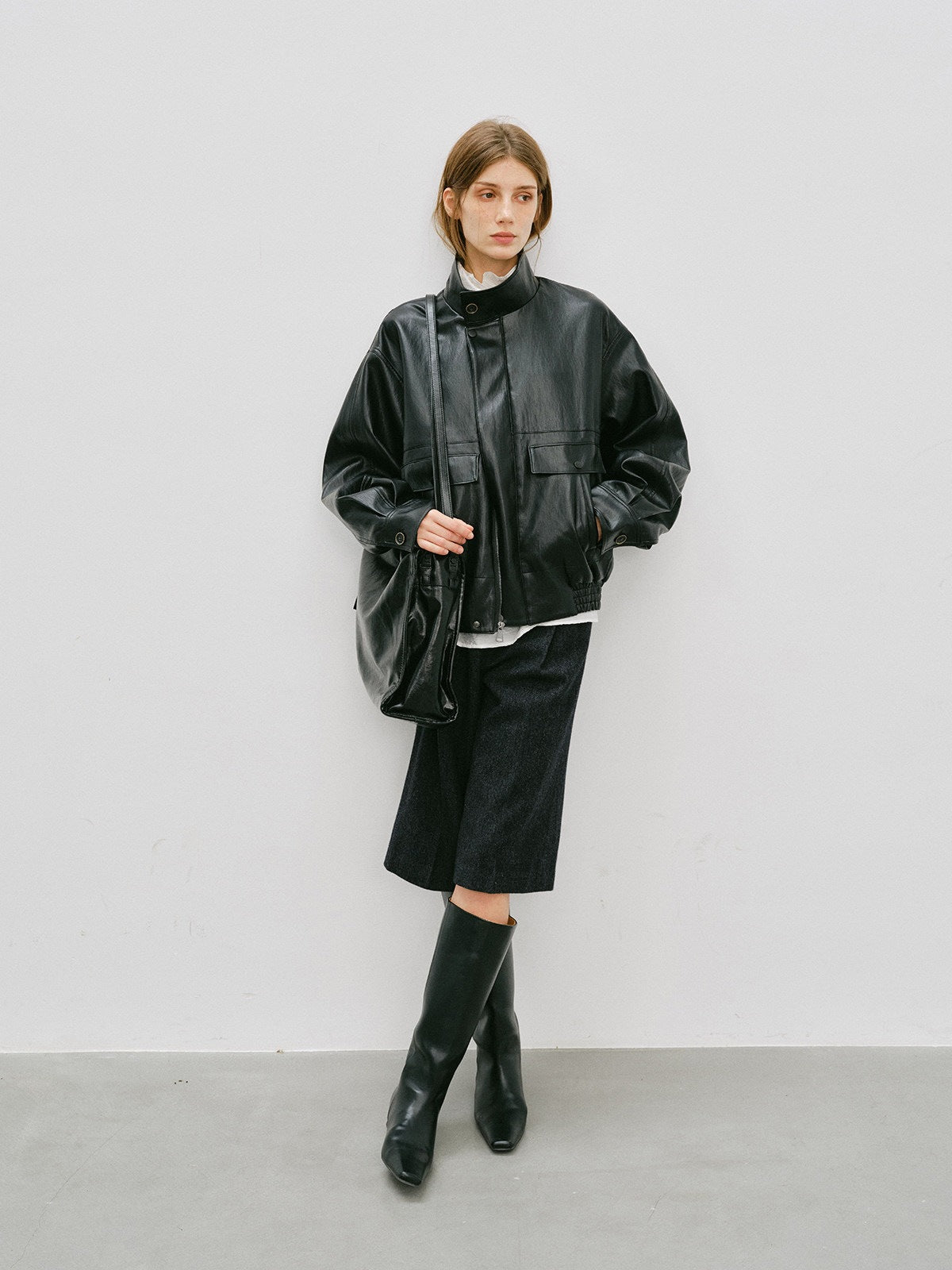 Black PU leather short jacket with stand-up collar and flap pockets, front view