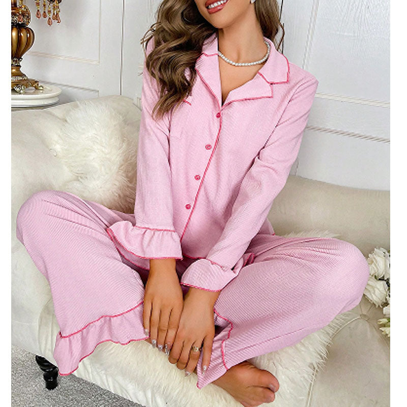 Women’s pink button-front pajama set with turn-down collar, long sleeves, and pants.
