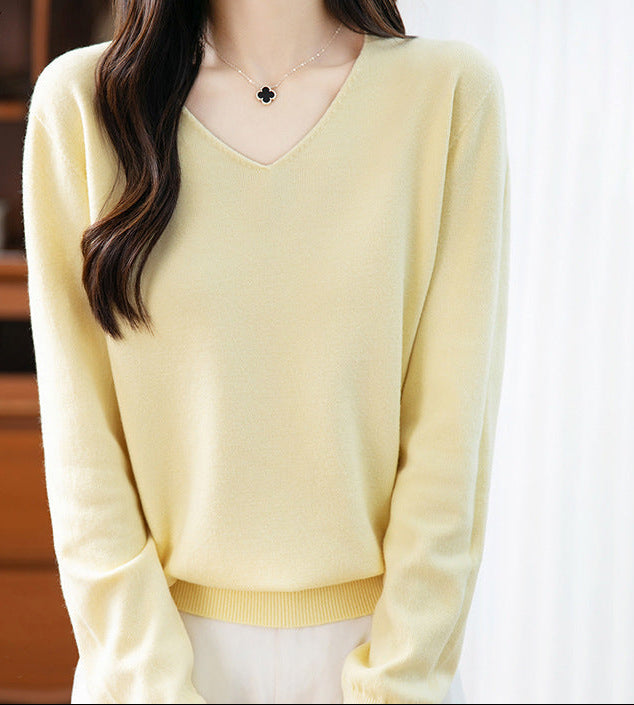 Women's V-neck cashmere sweater in pale yellow, long sleeves, ribbed hem and cuffs.