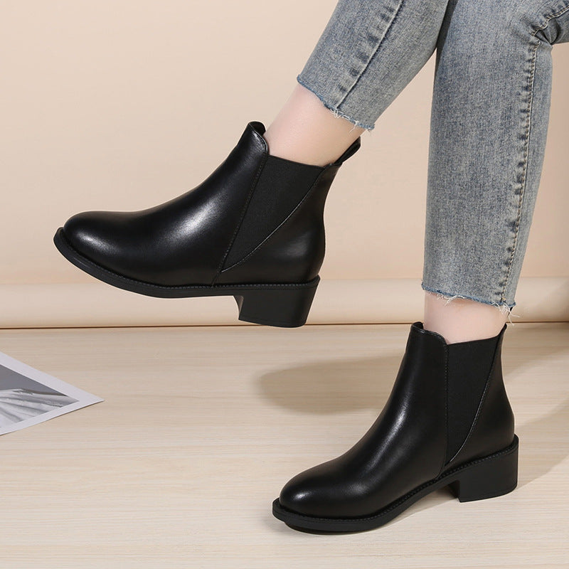 Black women's chelsea boots with chunky block heel, round toe, pull-on.