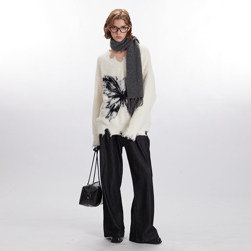Off-white loose pullover sweater with round neck, long sleeves, and black butterfly print