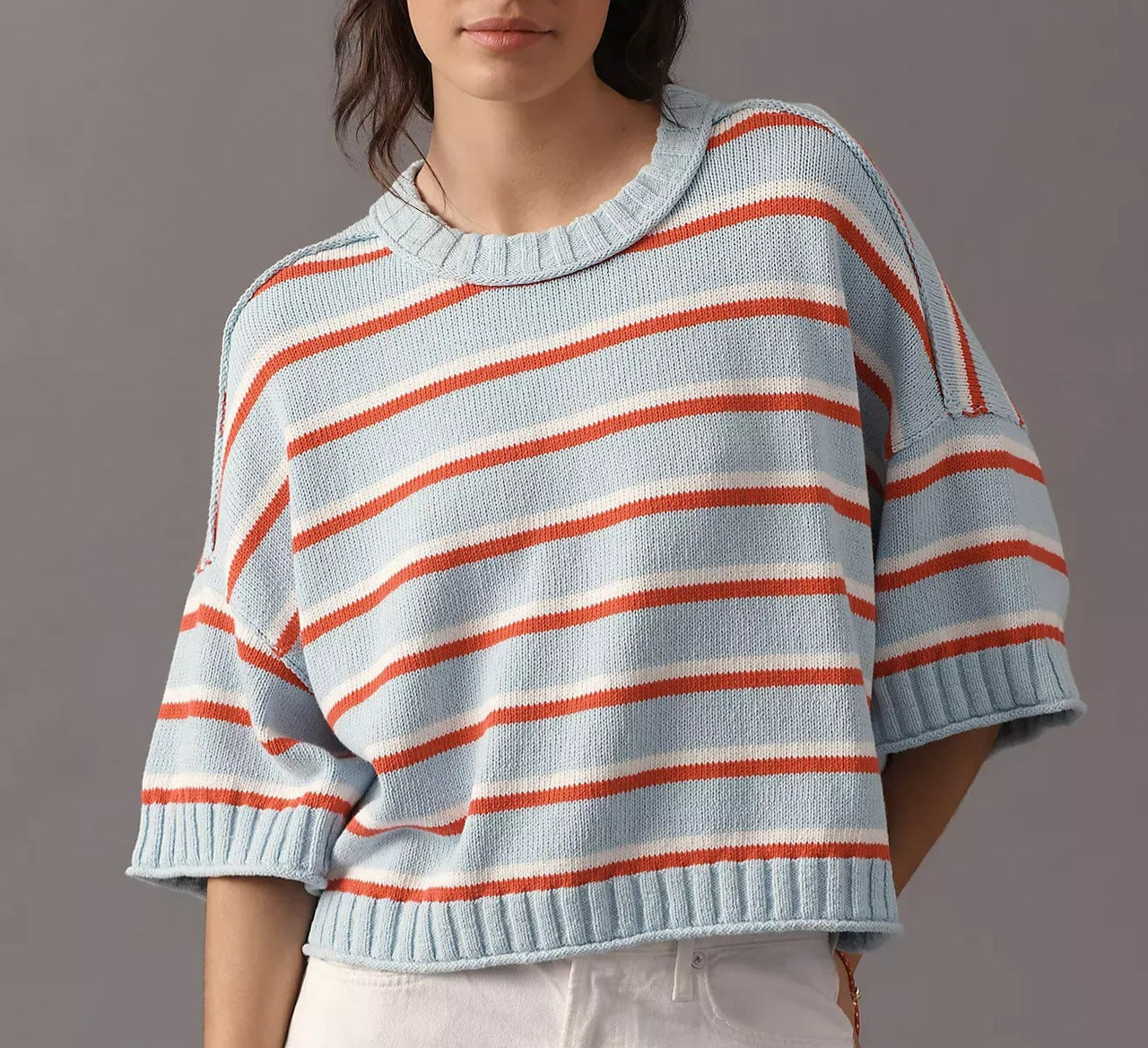 Women’s striped knit sweater, light blue with orange and white stripes, short sleeves