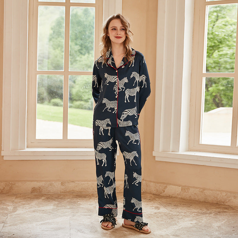 Navy women's zebra print pajama set with long sleeves, button front, and matching pants