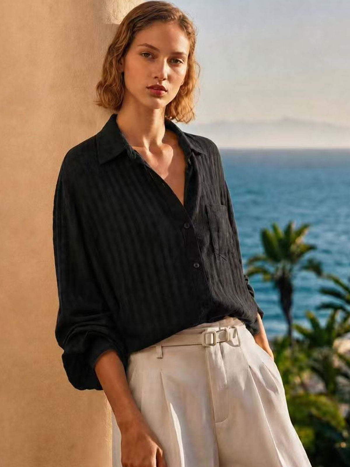 Black long-sleeve collared button shirt with textured fabric and relaxed drape