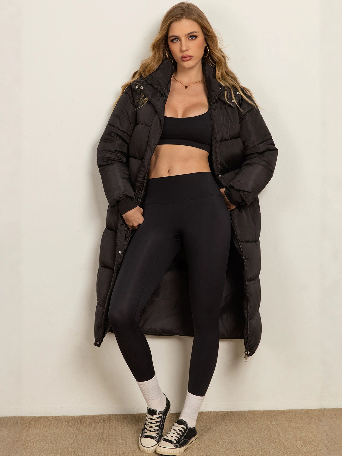 Women's black long padded coat with hood, button front and side pockets