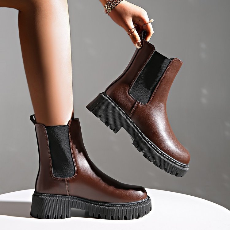Women's brown Chelsea ankle boots with black elastic side panels and chunky tread sole