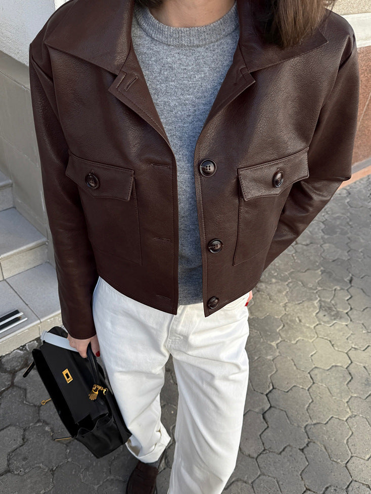Brown leather biker jacket front with two flap pockets and buttoned placket