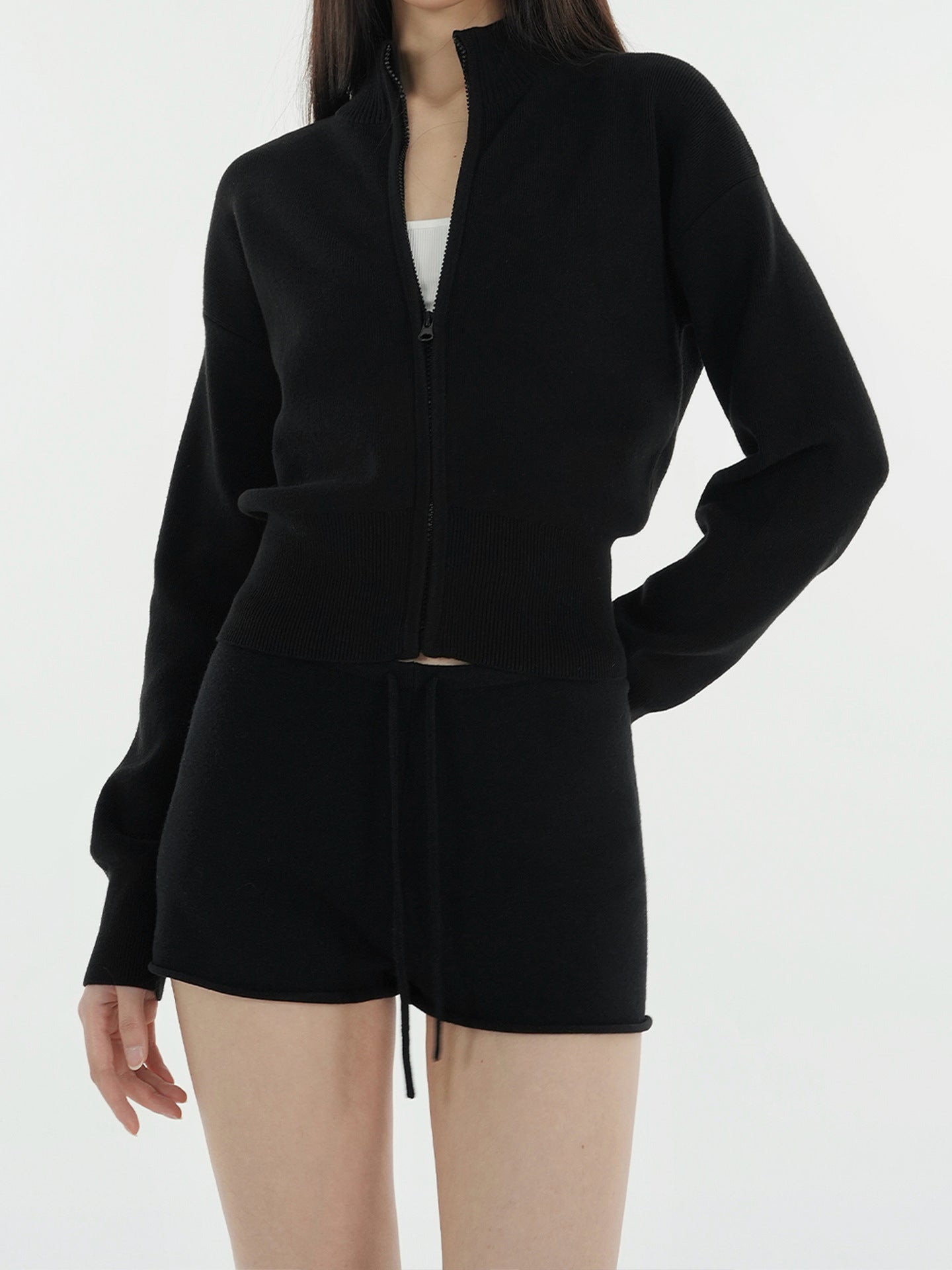 Black cropped zip-up mock neck knit cardigan with ribbed waist hem